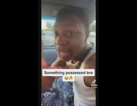 Guy in white tank top free styles in car