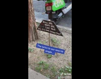 Cameraperson reads a weirdly phrased pick up your dog poop sign