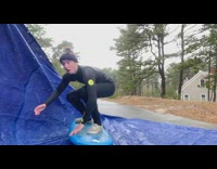 Guy pretends to surf blue tarp 