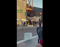 Guy film girl checkered dress town square