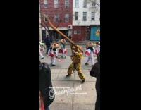 Jaguar costume with whip dances with Mexican flag guys in sombreros