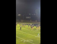 Line of football players at practice skipping running sideways