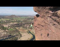 Guy slacklines across mountain canyon, bounces back and forth then falls off