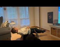 Man lay on floor bench press his son