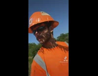 Guy orange hard hat with plants on his hat