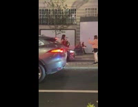 Woman in red dress and a bouquet of flowers on the street