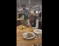 Girl breaking apples by hitting it with her head