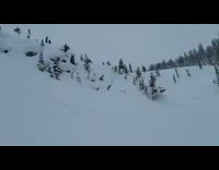 Skiier rolls downhill 
