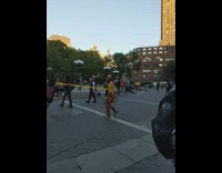 Man plays and ties with caution tape at the park in NY 