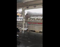 Robot arm cook put fries on fryer