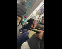 Two guys argue about barbecue sauce on a burger, in subway station