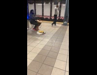 Man playing bongo while another dances 