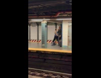 Man in suit busks at train station
