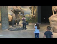 Daughter takes picture mom bear statue museum