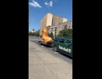 Huge brown boot statue carried on trailer