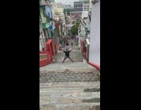 Man bald spread arms legs pose stairs