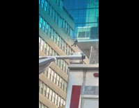 Man repel down building 