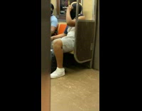 Guy in ski mask holds two snakes in his hand and head 