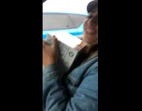 Woman carries 4 boxes of White Claw hard seltzer into the car