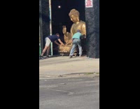 2 guys push a big Buddhist statue into garage 