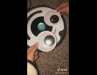 Girl puts googly eyes smile on roomba