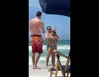 Boyfriend hug bikini girl  behind at beach