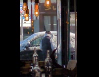 Guy uses skates scraped ice on car