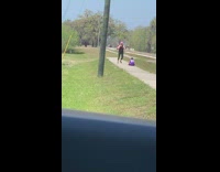 Purple jersey kid mom exercises sidewalk car