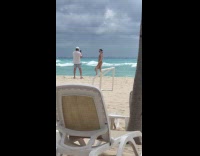 Woman beach net dress poses for photo
