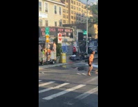 Man showers on the broken fire hydrant