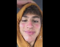 Guy in orange hoodie talks about going to get a haircut 