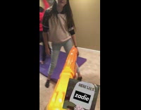 Orange nerf gun dart hits glasses friends 