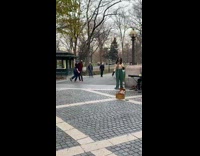 Couple dance while lady sings at park 