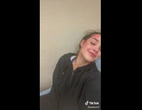 Lady Poses for Camera on Hospital Bed