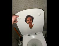 Picture of guy taped to toilet lid 