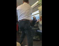 Man in business suit gets in a fist fight with guy in neon green shirt on the subway 