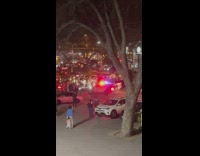 Crowd push back and throw fireworks at police car