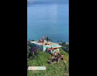 Woman tank top jump shot roof beach