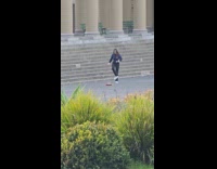 Woman in sweater tiktok dance at park