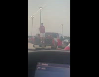 Man red shirt stand trunk of car pictorial