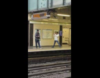 Man hold umbrella wait pose train station