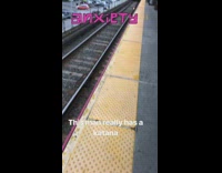 Man carries a katana on his back at subway station