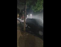 Dark colored car parked in front of hydrant 