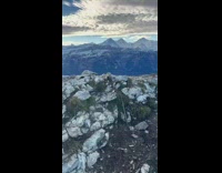 Man Shows Mountain Range and Clouds Below