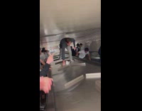 Guy crawls over subway divider