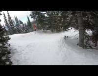 Skier rides down mountain while playing hip hop music, grinds on rail and falls down in snow