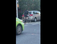 Guy riding bicycle drags office chair 