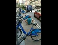 Guy does sit ups next to bikes 
