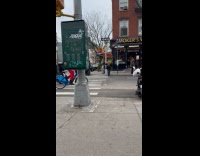 Man rides bike balance tv on head
