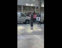 Man on truck playing saxophone for people drive by